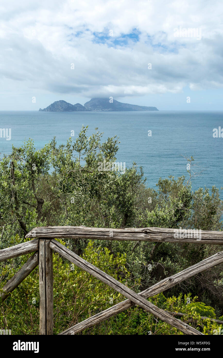 Mediterranean sea views with wooden fence and Capri island in the background, Sorrento, Naples, Italy Stock Photo