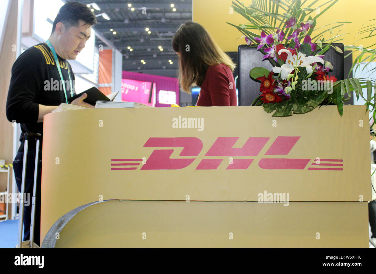 FILE--People visit the stand of German logistics giant DHL Express during  the First China International Import Expo (CIIE) in Shanghai, China, 7 Nov  Stock Photo - Alamy