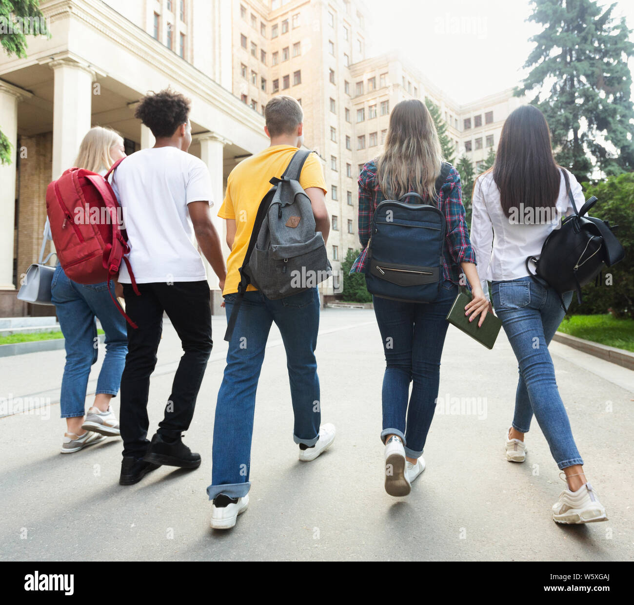 Group of students walking together in campus after studies Stock Photo