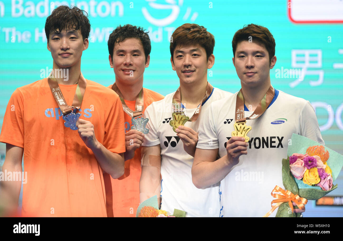 Ko Sung-hyun and Shin Baek-cheol, right, and Kim Gi-jung and Lee Yong-dae of South Korea pose with their trophies after their final match of men's dou Stock Photo