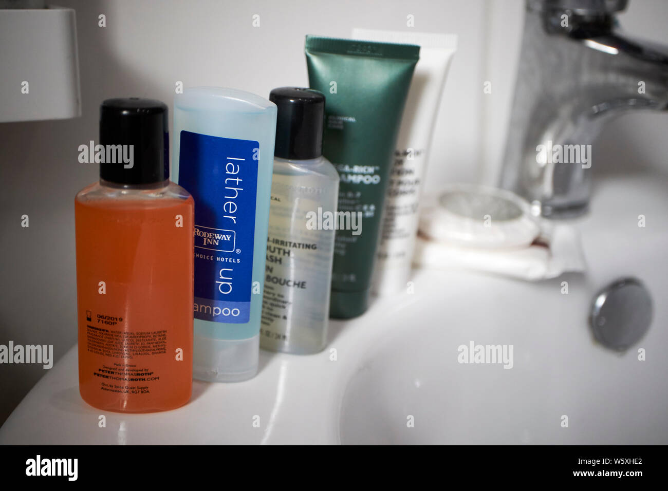 selection of mini bottles of collected toiletries including shower gels and soaps from various hotels usually discarded as plastic waste Stock Photo