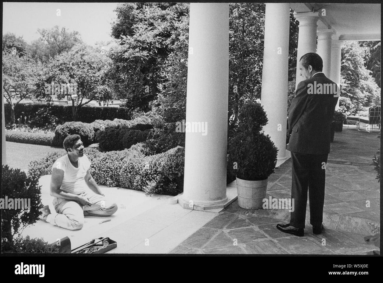 Richard M. Nixon talking to a carpenter laying the sub-carpet for Tricia Nixon's wedding.; Scope and content:  Pictured: Richard M. Nixon. Stock Photo