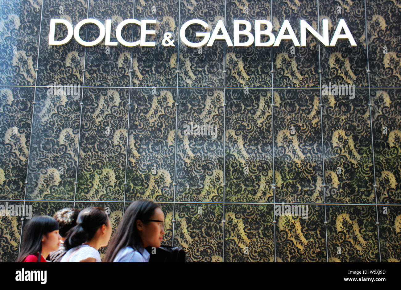file-pedestrians-walk-past-a-boutique-store-of-dolce-gabbana-in