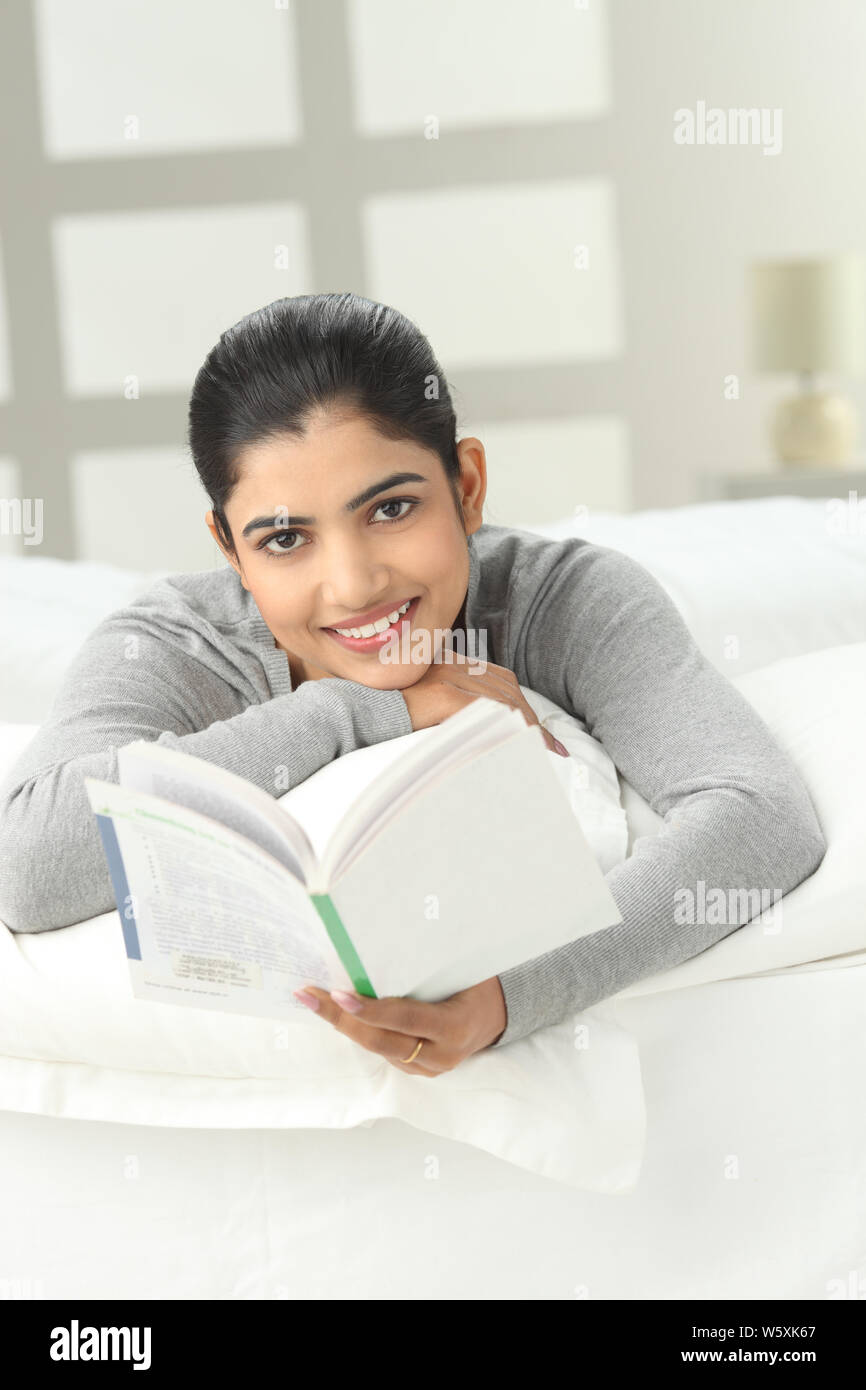 Indian girl reading book bed hi-res stock photography and images - Alamy