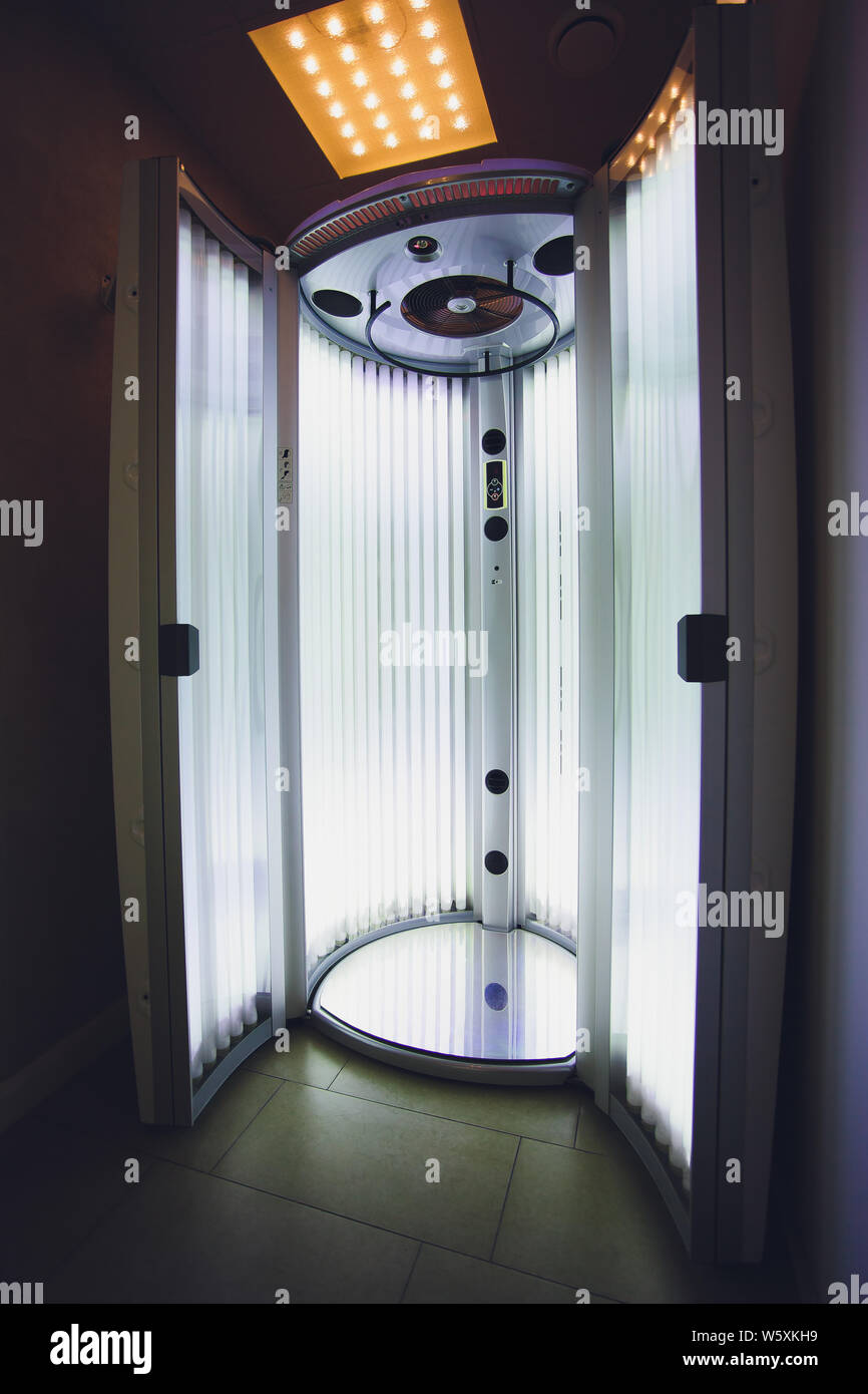 Vertical Tanning turbo Solarium Light Machine with glowing blue light ultraviolet lamps for
