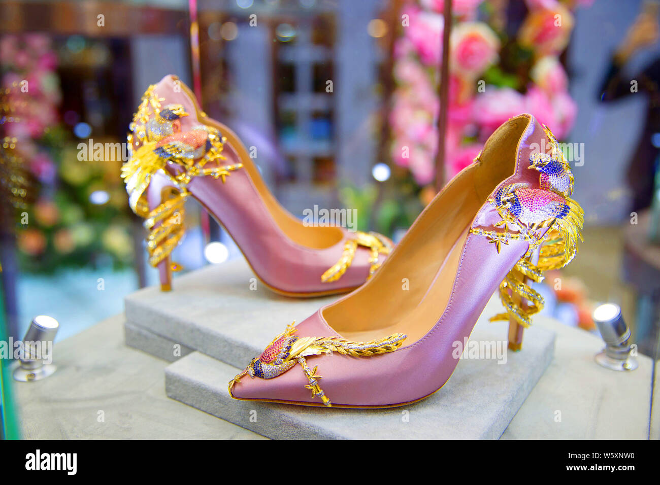 A pair of Jimmy Choo's luxury high heel shoes is on display during the First China International Import Expo (CIIE) and the Hongqiao International Eco Stock Photo