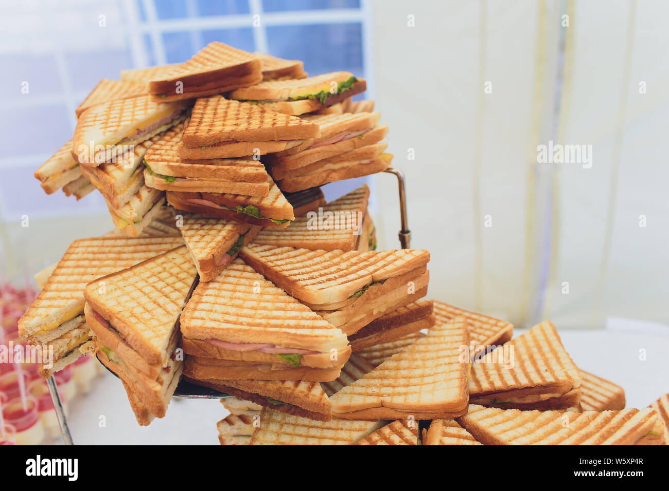 Cut platter of mixed sandwich triangles catering. Stock Photo