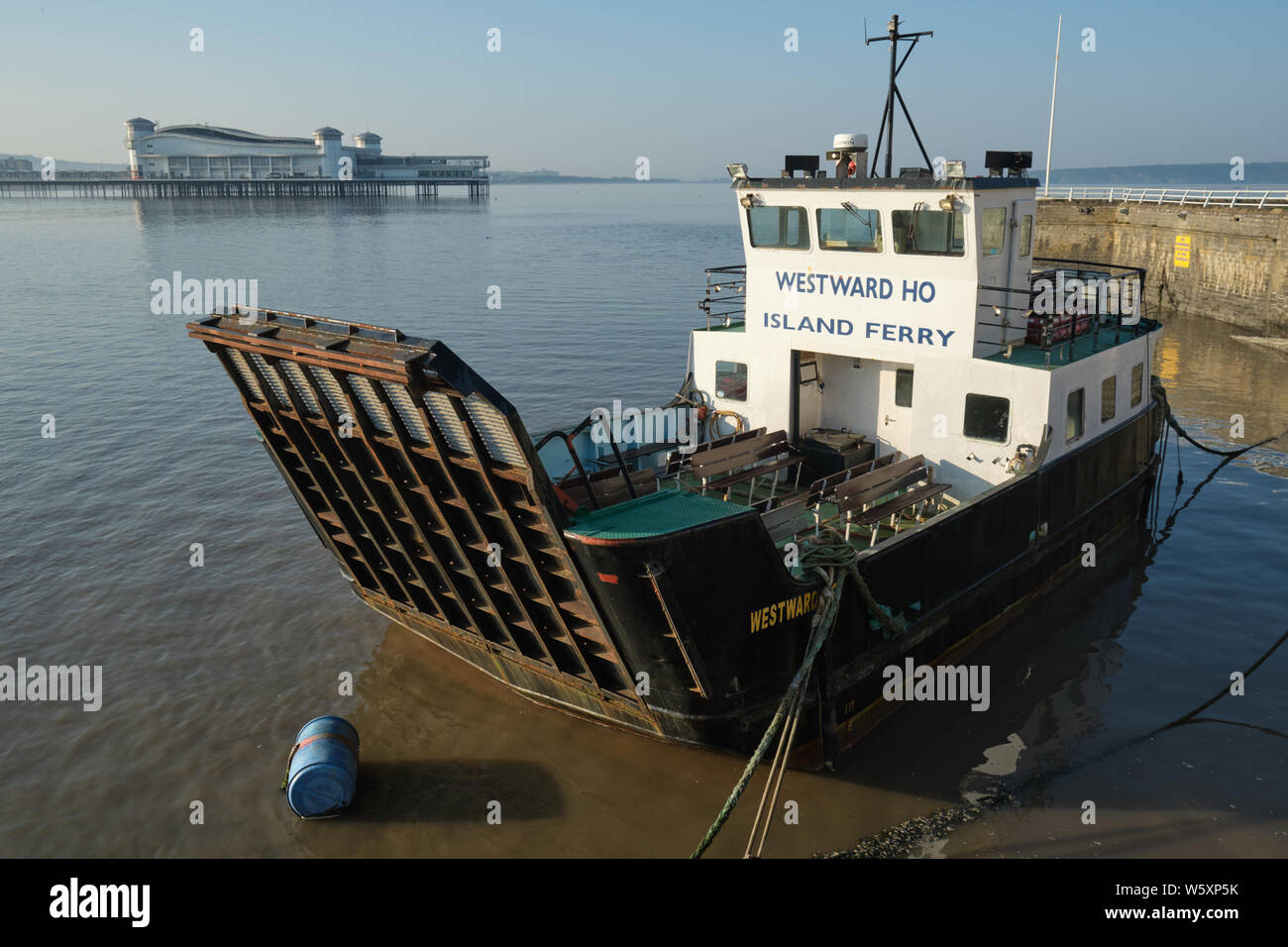 Westward Ho, ferry boat tied up alongside at Knightstone island in Weston Super Mare, at high tide with the grand Pier in the background. Stock Photo