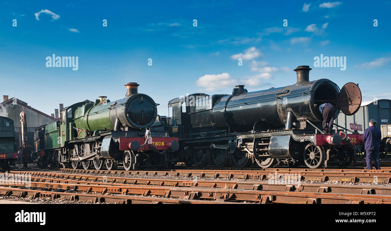 Preserved locomotives 'Cookham Manor' and  a 2-8-0 goods locomotive standing outside Didcot TMD at The railway centre in Oxfordshire. Stock Photo