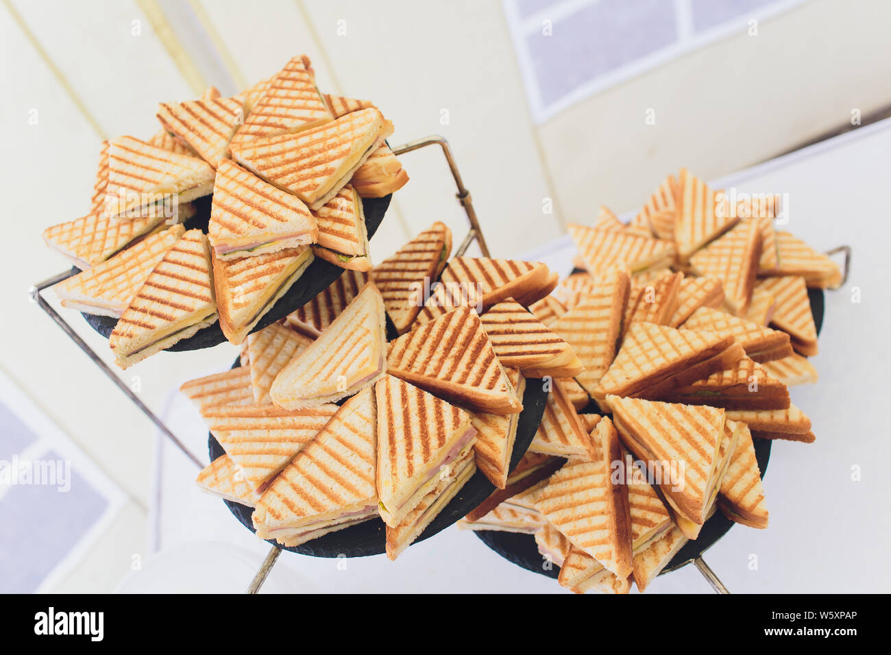 Cut platter of mixed sandwich triangles catering. Stock Photo