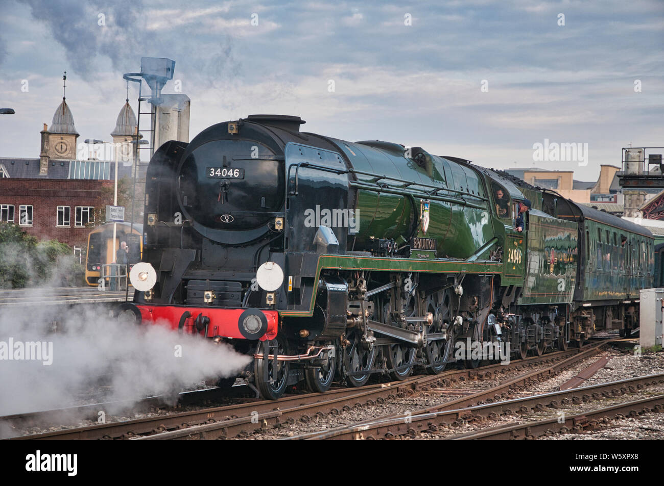 Rebuilt Bullied Pacific Class locomotive 34046 'Braunton' leaves Temple meads railway station with a summer excursion Stock Photo