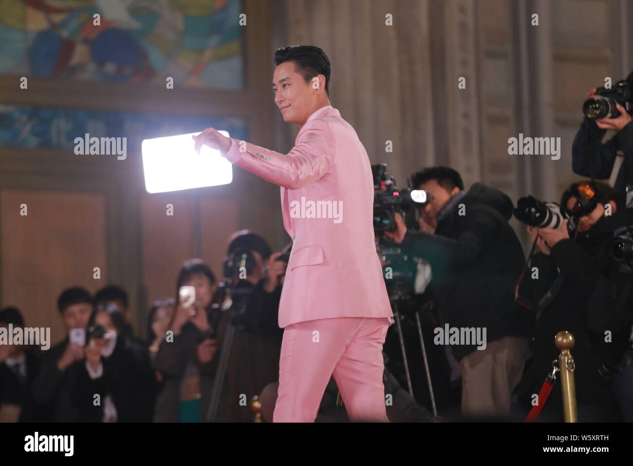 South Korean actor Ju Ji-hoon poses as he arrives on the red carpet for the 39th Blue Dragon Film Awards in Seoul, South Korea, 23 November 2018. Stock Photo