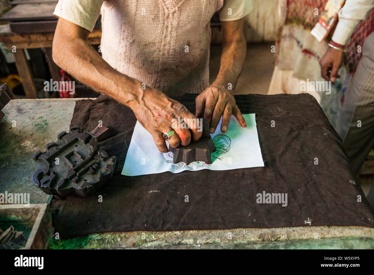 A craftsman doing block printing on fabric in Jaipur, India. Stock Photo