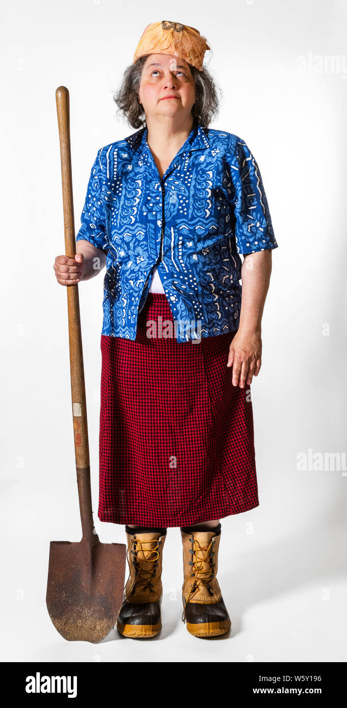 Senior woman poses wearing silly, funny, mismatched outfits and ready for a fashion show runway highlighting the weird, zany, quirky and eccentric. Stock Photo