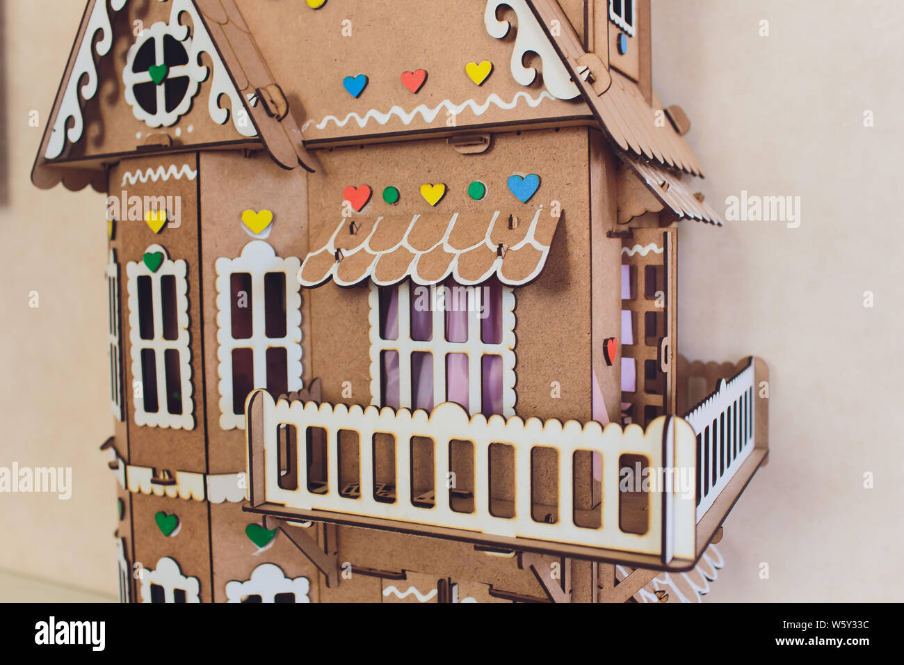 White wooden decorative houses on blue wall background. Toy houses in Christmas decor. The