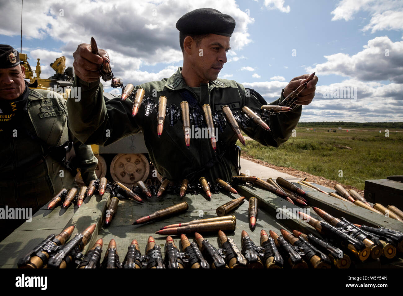 Moscow region, Russia. 30th, July 2019 Venezuelan tank crew preparing ammo for heavy machine gun for tank T-72 to take part of training shooting before start the international competition 'Tank biathlon-2019' at the military range 'Alabino', Moscow region, Russia Stock Photo