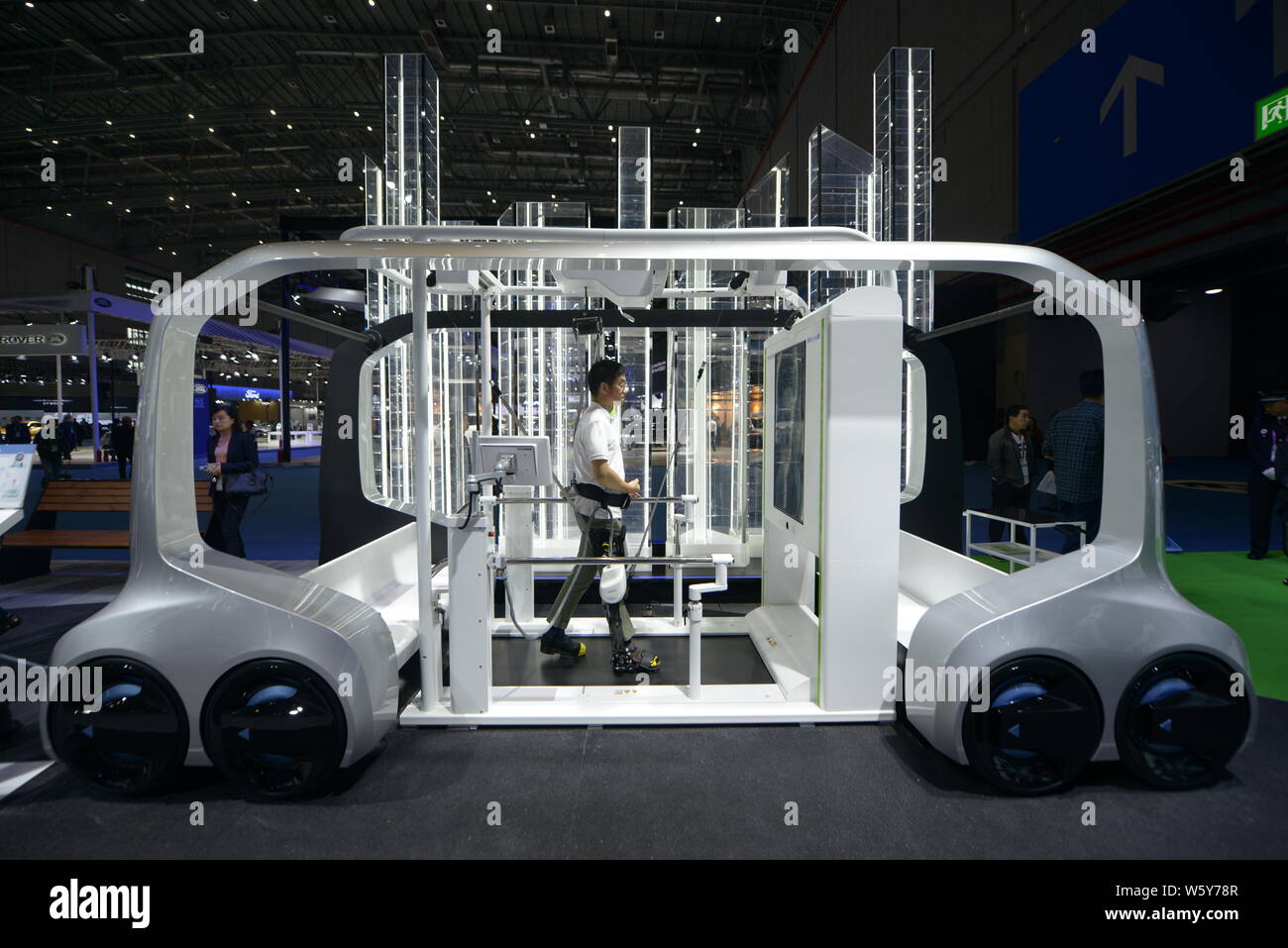 A visitor tries out Toyota's new robotic leg brace, the Welwalk WW-1000, during the First China International Import Expo (CIIE 2018) in Shanghai, Chi Stock Photo