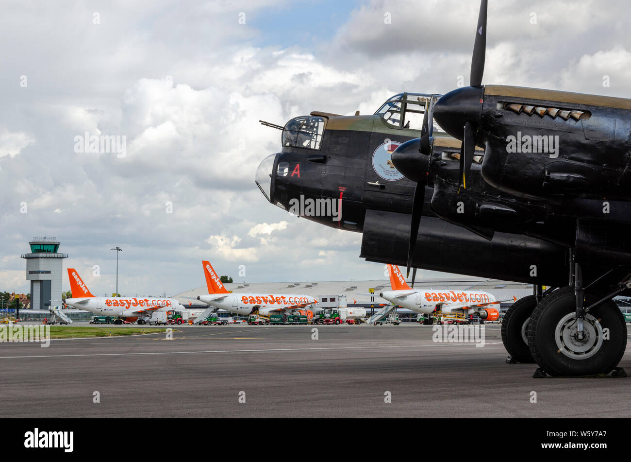 Canadian Warplane Heritage Museum Avro Lancaster FM213, known as the Mynarski Lancaster at London Southend Airport with easyJet planes and atc tower Stock Photo