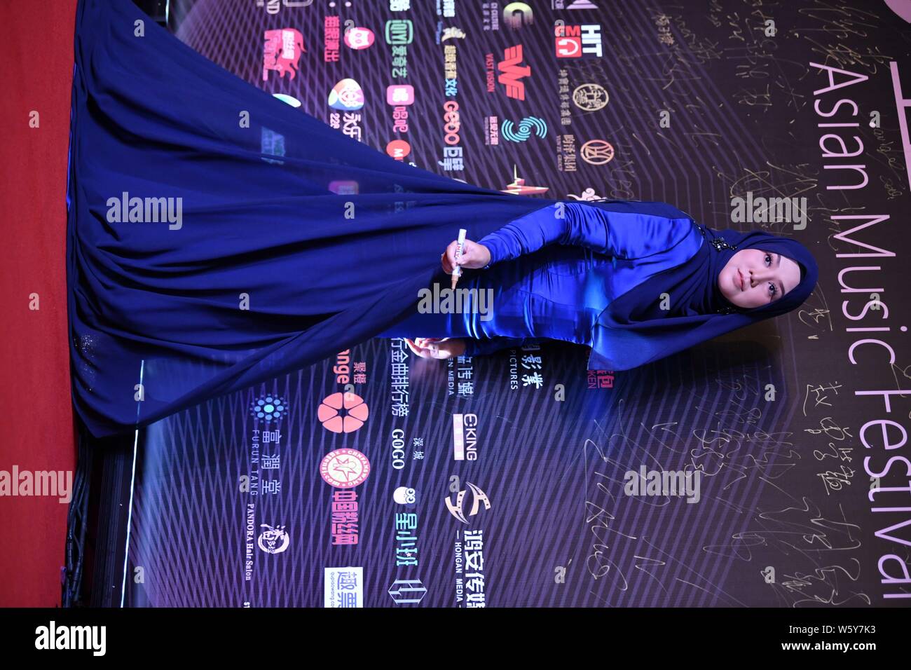 Malaysian singer-songwriter Shila Amzah poses as she arrives on the red