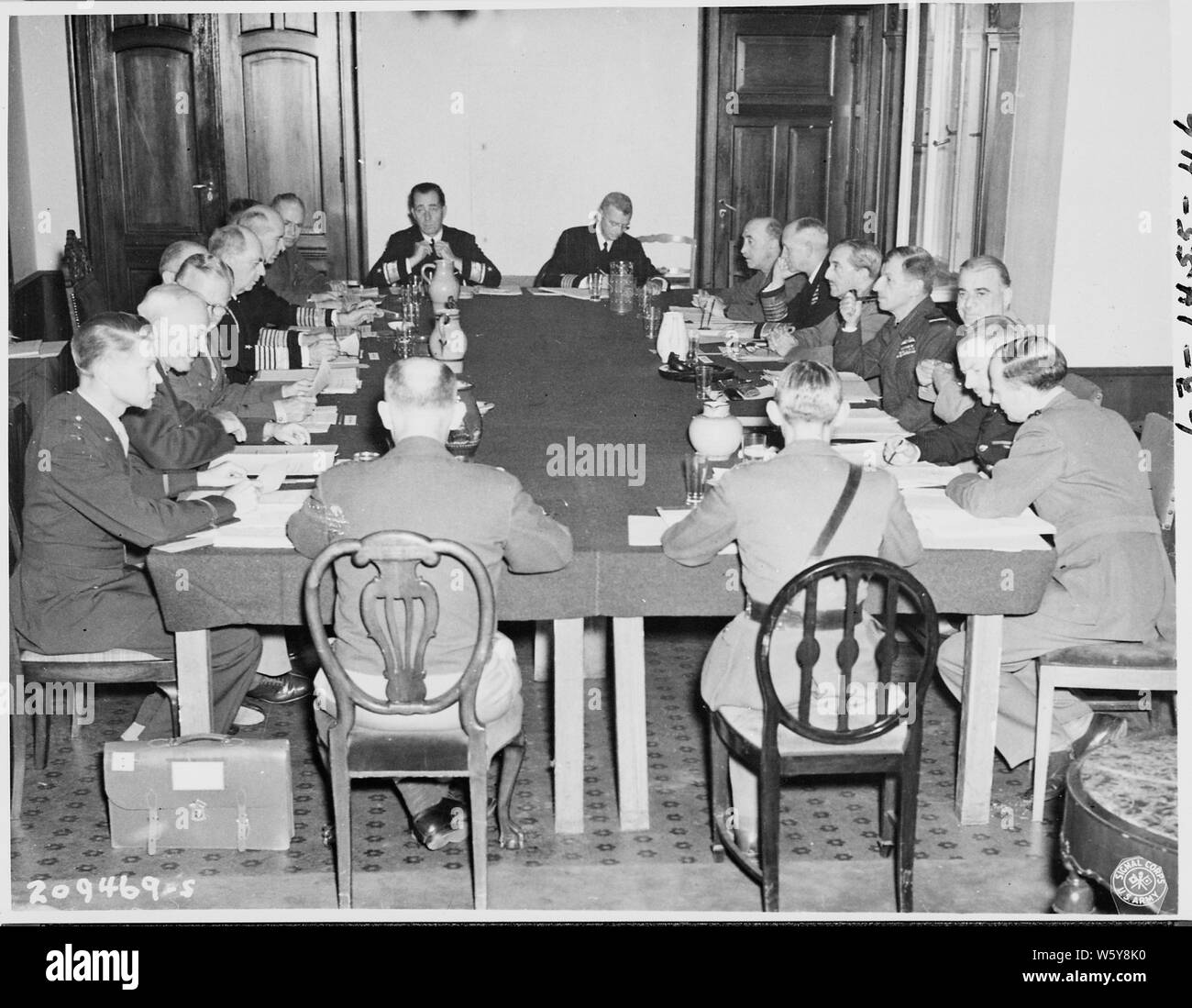 The Combined Chiefs of Staff meet on the 4th day of the Potsdam Conference in Germany. Clockwise, L to R: Maj. Gen. Lauris Norstad, Gen. Henry H. Arnold, Gen. George C. Marshall, Brig. Gen. Andrew J. McFarland, Adm. William D. Leahy, Adm. Ernest J. King, Vice-Adm. C. M. Cooke, Jr., Gen. Brehon B. Somervell, Rear Adm. H. A. Flanigan, Captain C. J. Moore, Lt. Gen. Sir Gordon McCready, Adm. Sir Andrew Cunningham, Field Marshall Sir Alan Brooke, Marshall Sir Charles Portal, Gen. Sir Hastings Ismay, Gen. L. C. Hollisd, Brig. A. T. Cornwall-Jones, Col. Thomas Haddon, and Lt. Gen. John E. Hull. Stock Photo