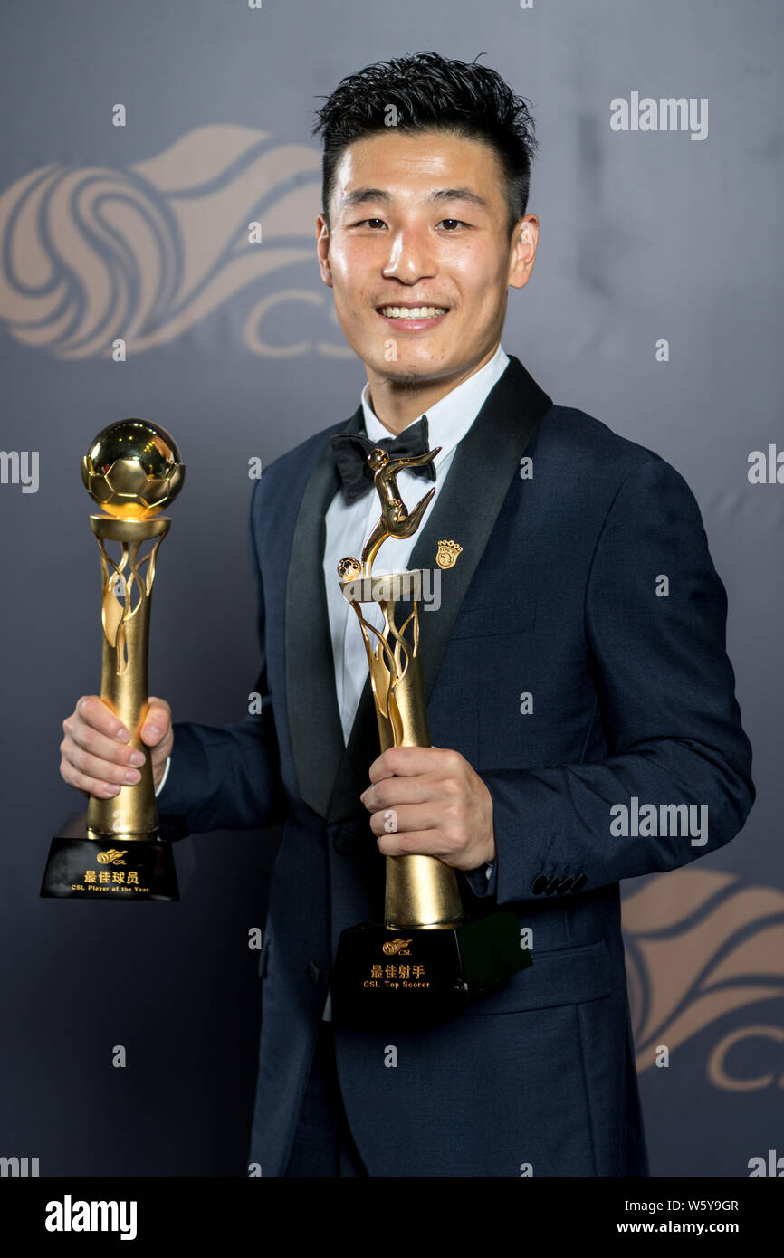 Chinese football player Wu Lei of Shanghai SIPG poses with trophys for the CSL Top Scorer and Player of the Year Awards at the 2018 Chinese Super Leag Stock Photo