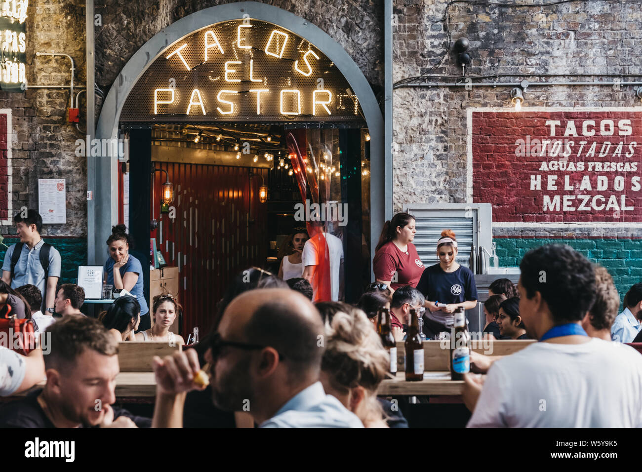 London, UK July 23, 2019 People sitting at the outdoor tables of El Pastor Tacos restaurant