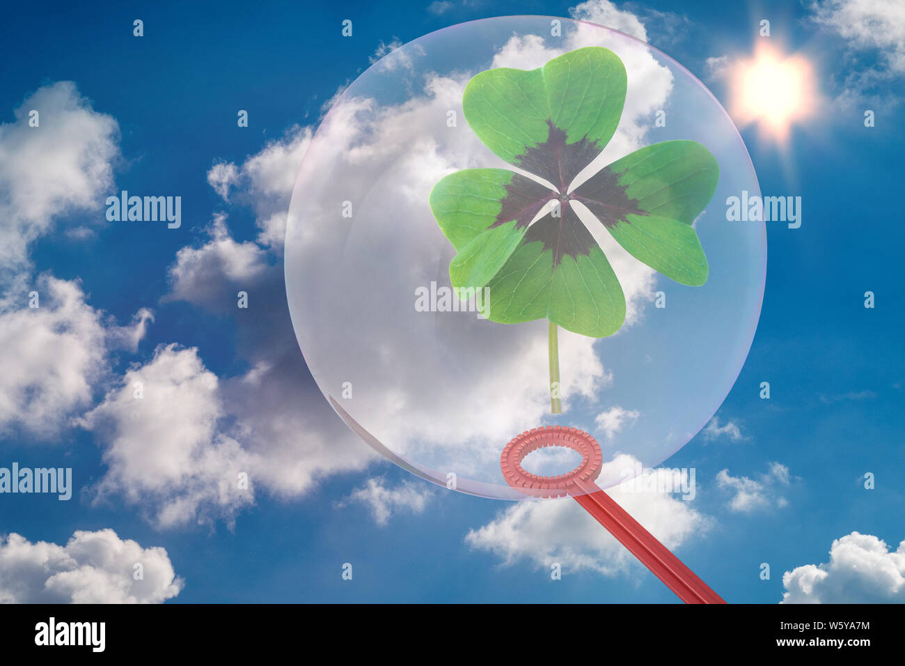 A lucky cloverleaf is surrounded by a fragile soap bubble - 3D-Illustration Stock Photo