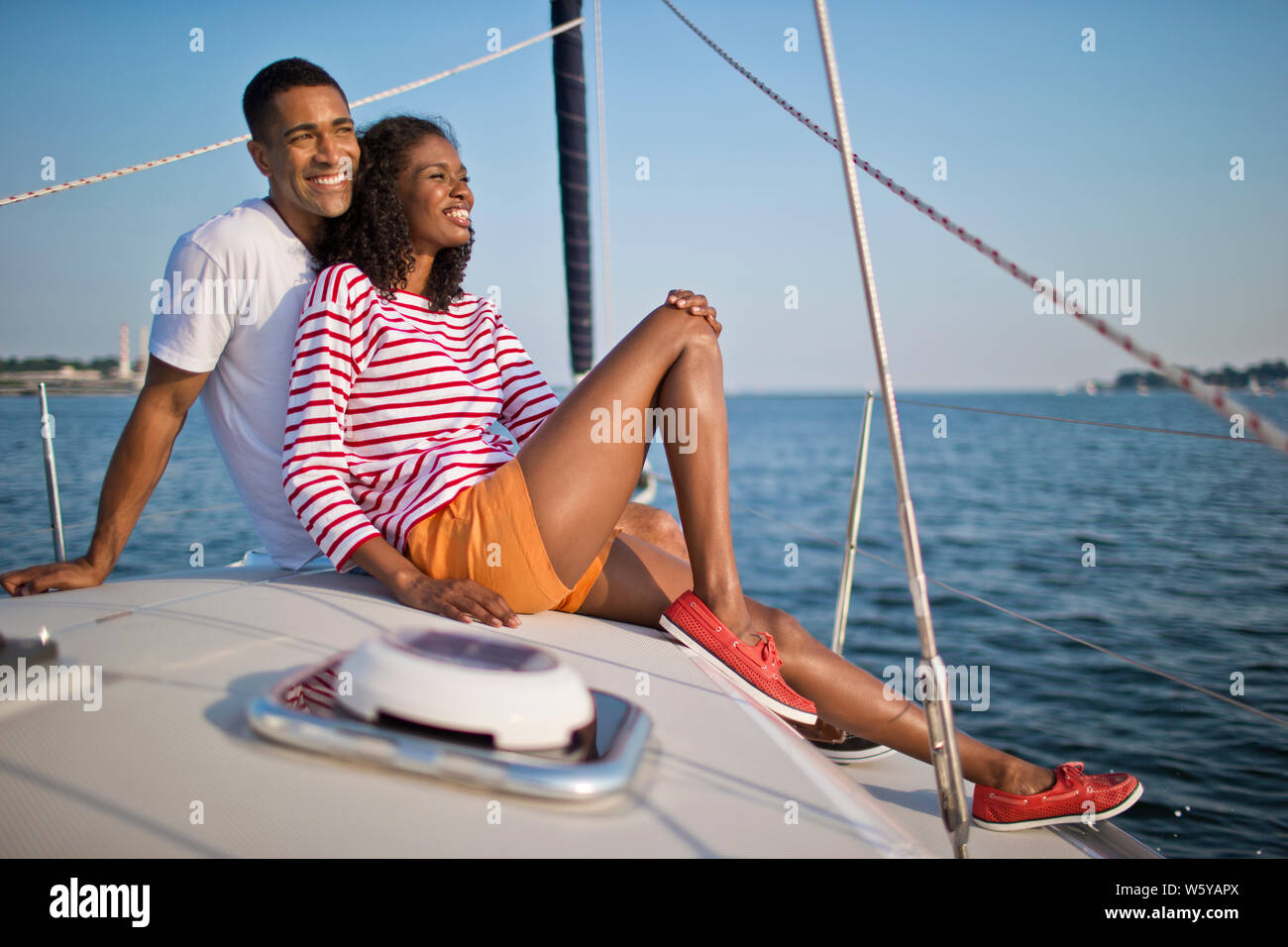 Happy young couple relaxing and having fun while sailing. Stock Photo