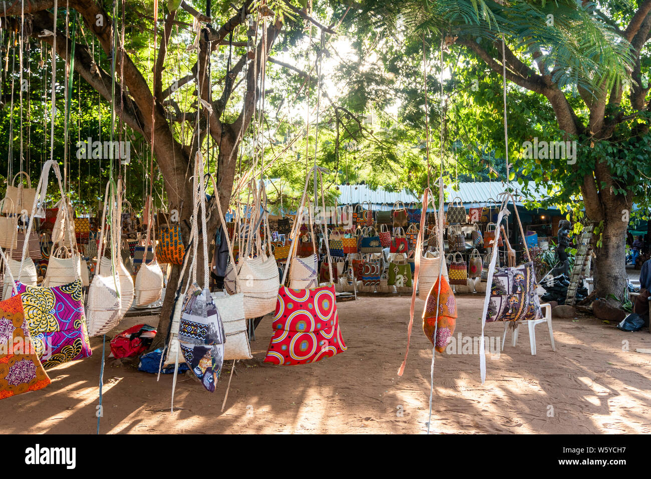 traditional african market selling colorful bags hanged on trees feima maputo mozambique W5YCH7