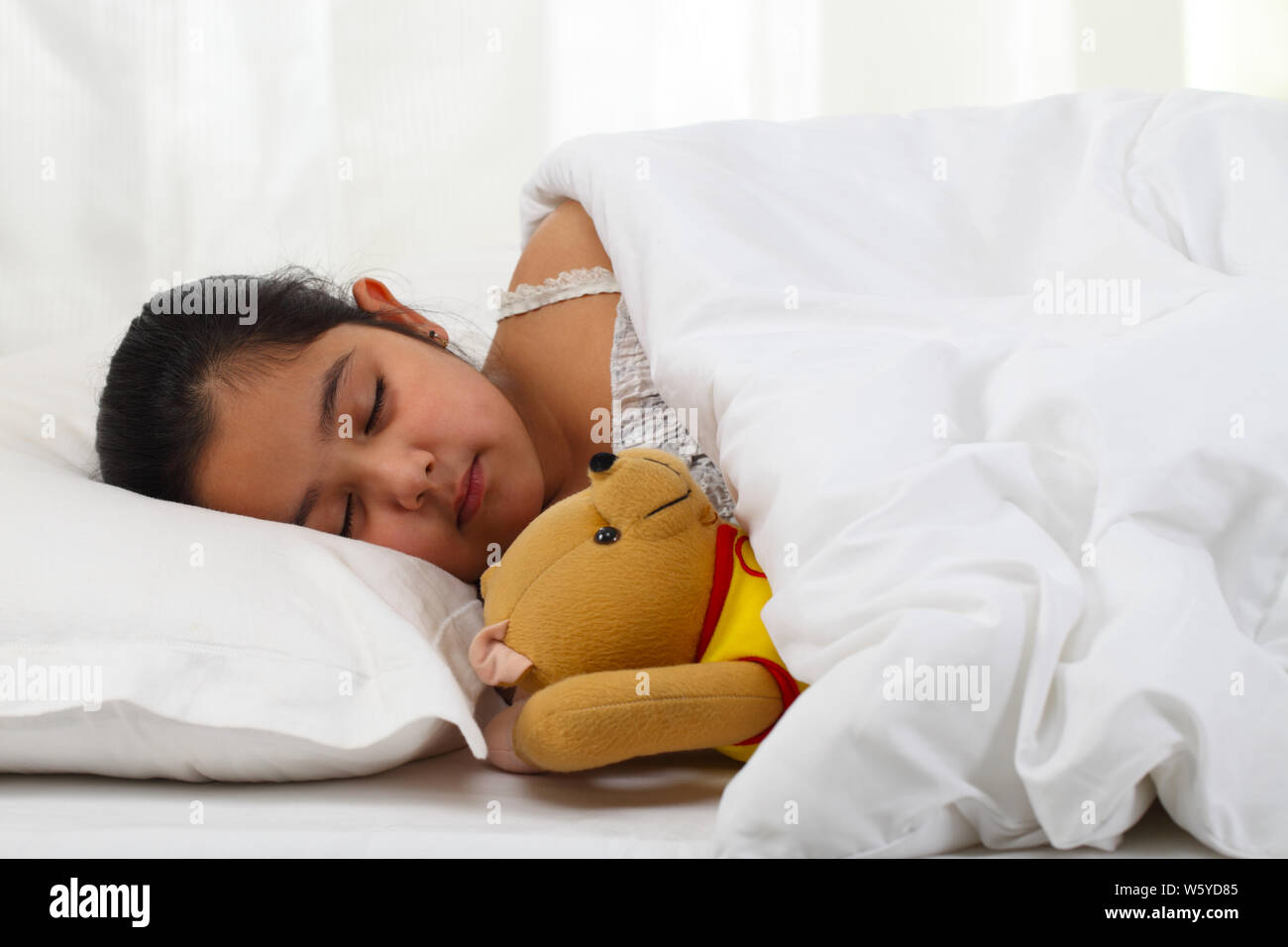 Girl with teddy bear sleeping in the bed Stock Photo - Alamy
