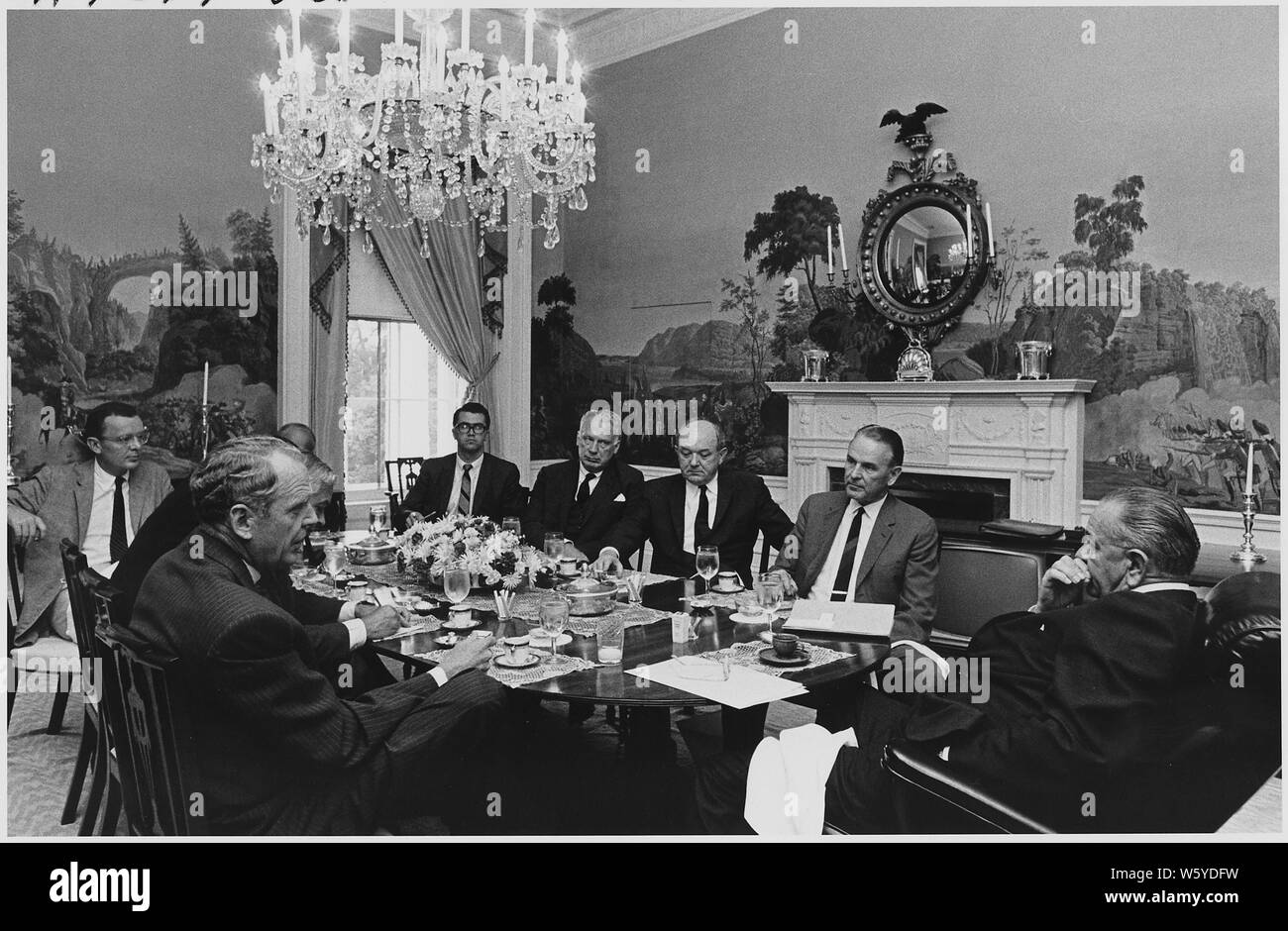 Tuesday Luncheon; Scope and content:  Location: White House Dining Room. Depicted: (clockwise from President Lyndon B. Johnson) Secretary of Defense Clark Clifford, Secretary of the Navy Paul Nitze, Harry McPherson, Walt Rostow, Assistant Press Secretary Tom Johnson, George Ball, Secretary of State Dean Rusk, General MaxwellTaylor. Stock Photo