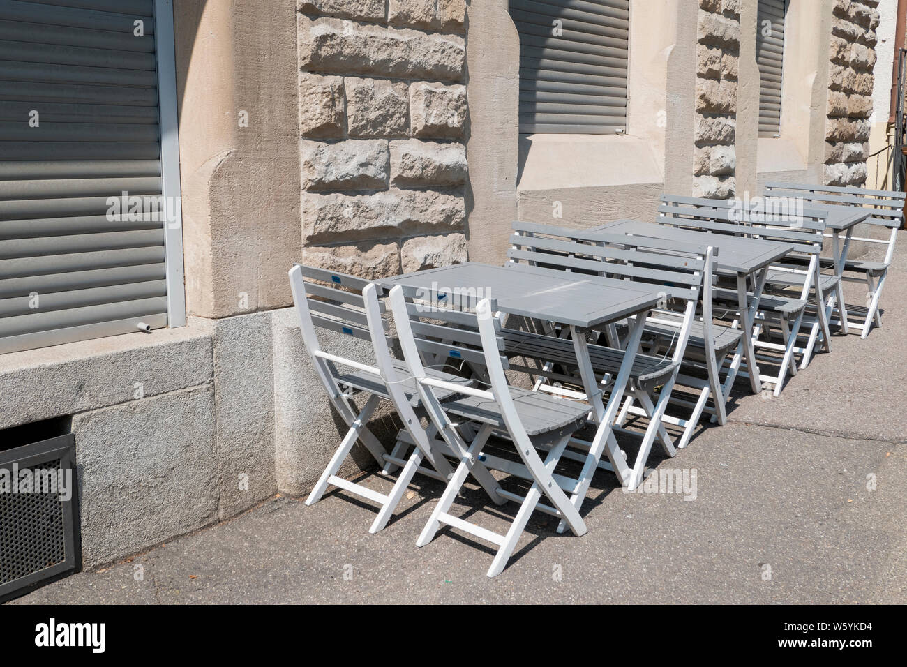 empty chairs and tables in front of a restaurant Stock Photo - Alamy