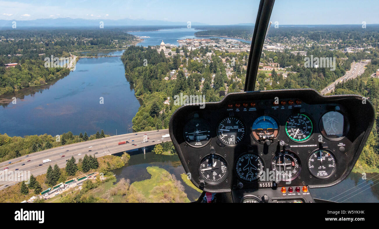 Aerial view from helicopter with instruments in foreground, looking north of Washington State Capitol building and Budd Inlet, the south end of Puget Sound. Stock Photo