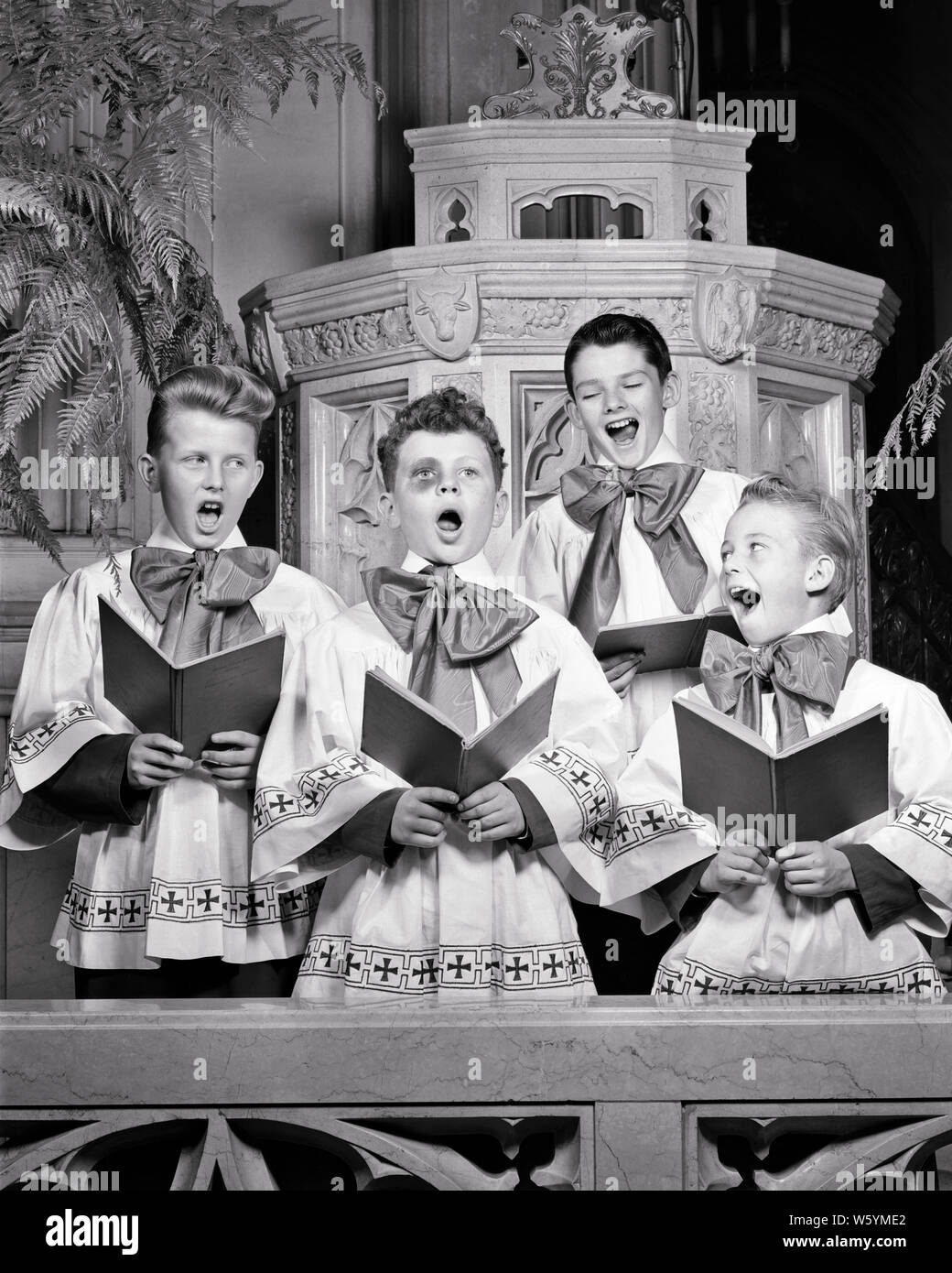 1940s THREE SINGING SMILING INNOCENT CHOIRBOYS EYING FOURTH GUILTY BOY STANDING IN MIDDLE WITH BIG BLACK EYE LOOKING AT CAMERA - c2811 HAR001 HARS TEAMWORK COMPETITION PLEASED JOY LIFESTYLE SATISFACTION RELIGION CELEBRATION HEALTHINESS COPY SPACE FRIENDSHIP HALF-LENGTH INSPIRATION FOURTH MALES RISK SPIRITUALITY SKIN B&W EYE CONTACT PERFORMING ARTS VISION TEMPTATION CHEERFUL ADVENTURE STRENGTH COURAGE POWERFUL IN SMILES BLACK EYE SURROUNDING CONCEPTUAL JOYFUL STYLISH BRUISE CHOIRBOY CHOIRBOYS GROWTH GUILTY HONORABLE JUVENILES PRE-TEEN PRE-TEEN BOY SHINER SOLUTIONS SOMEONE TOGETHERNESS Stock Photo