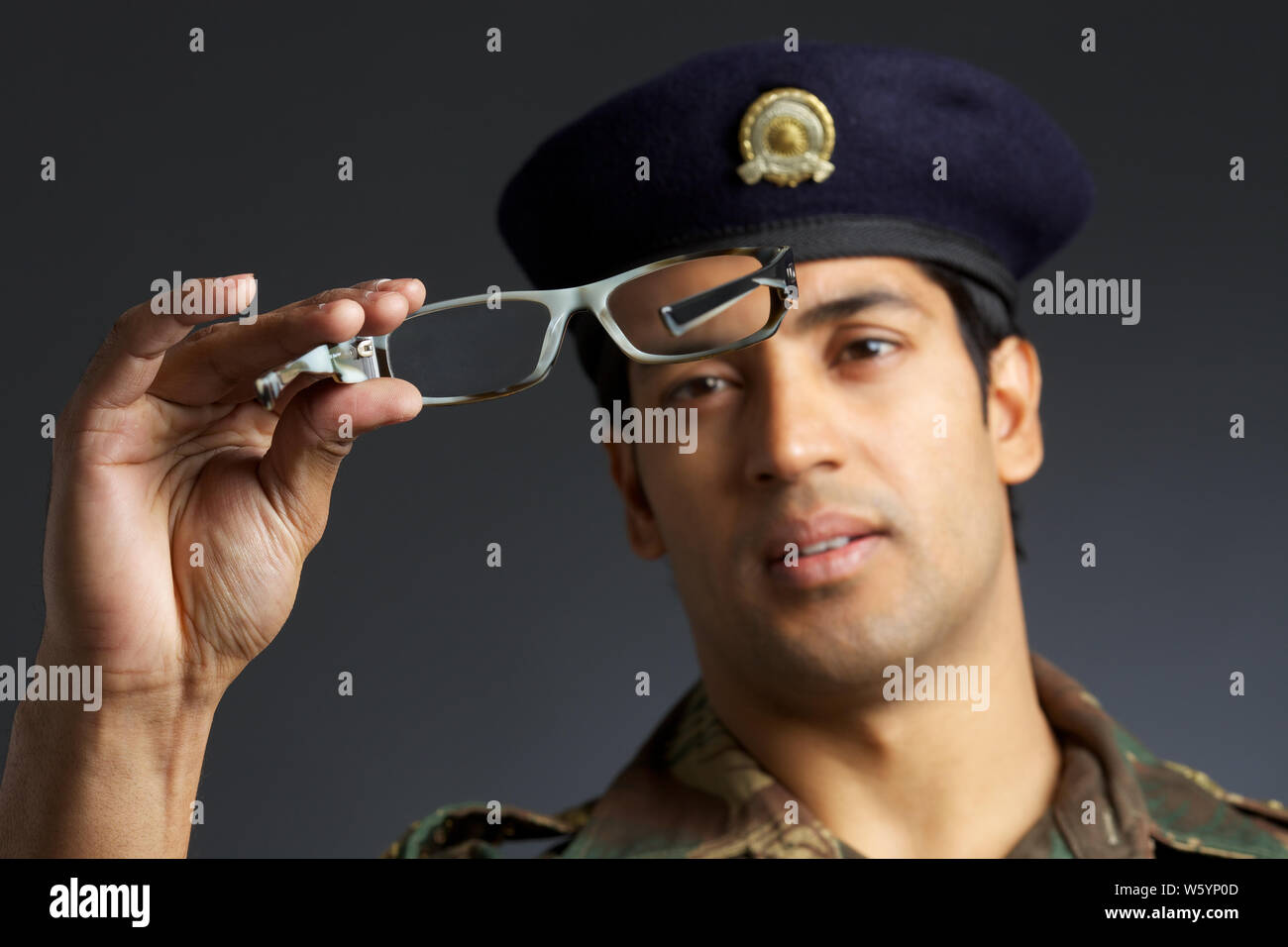 Army soldier holding an eyeglasses Stock Photo Alamy