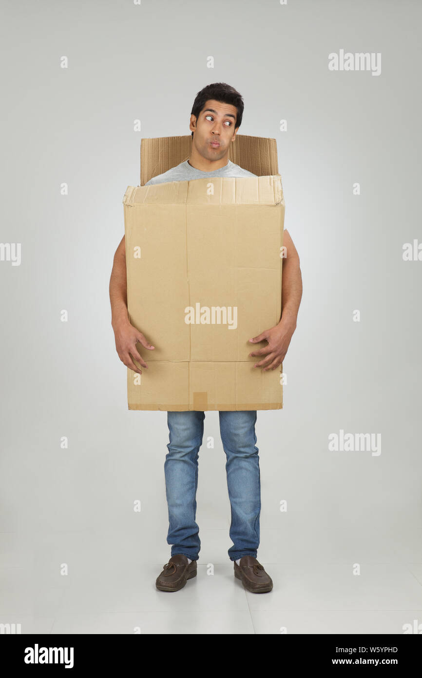 Man wearing cardboard box Stock Photo