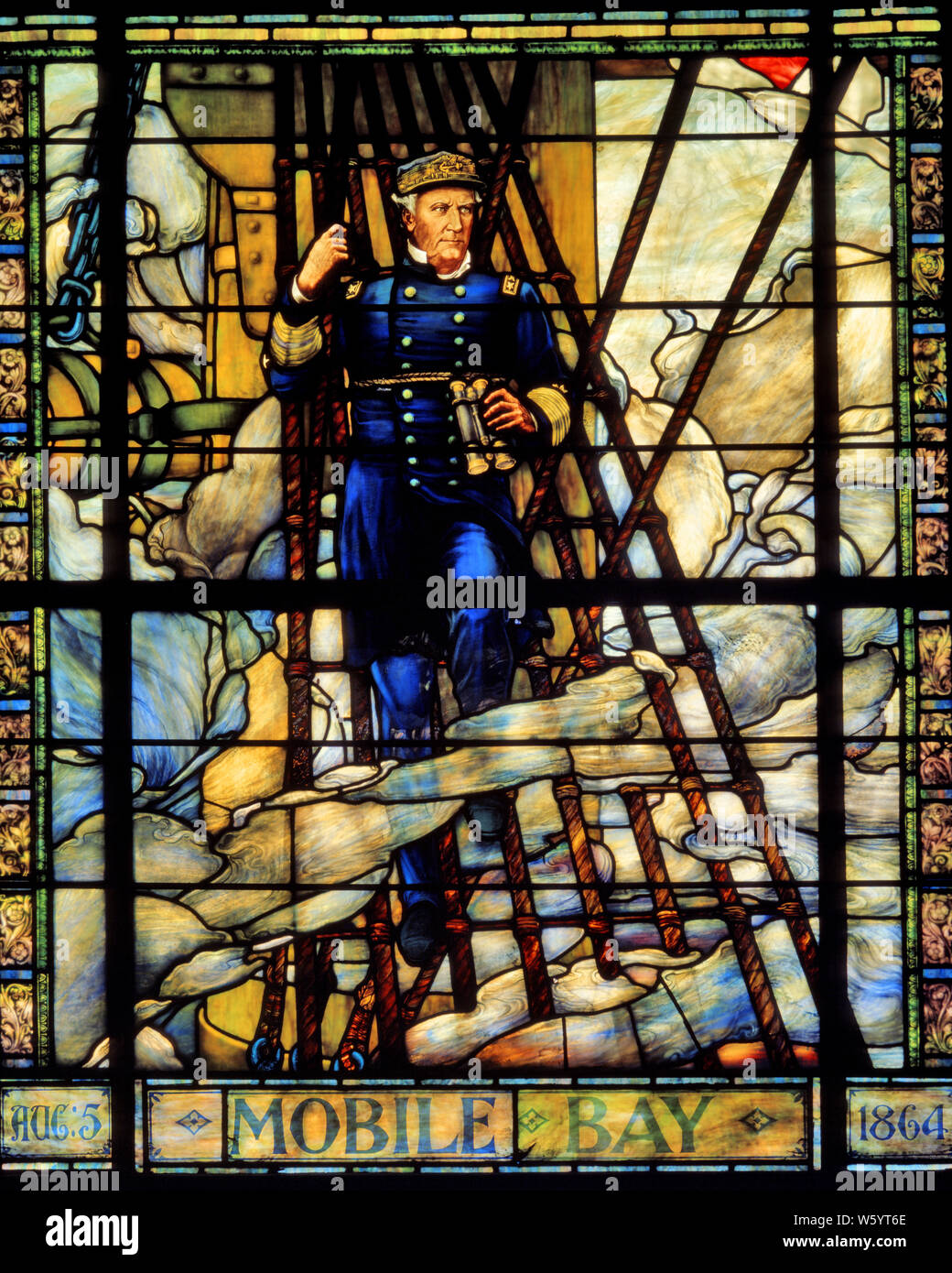 1860s ADMIRAL DAVID FARRAGUT AT 1864 BATTLE OF MOBILE BAY STAINED GLASS WINDOW IN CHAPEL AT US NAVAL ACADEMY ANNAPOLIS MD USA - km5760 VRE001 HARS MALES FORCE OFFICER WARS ADVENTURE STRENGTH STRATEGY ACADEMY MD NAVAL DAVID LEADERSHIP PRIDE AT IN UNIFORMS FORCES CONCEPTUAL 1860s NAVIES ANNAPOLIS AHEAD FARRAGUT REAR ADMIRAL USN DAMN THE TORPEDOES HERO STAINED GLASS 1864 ADMIRAL AMERICAN CIVIL WAR BATTLES CAUCASIAN ETHNICITY CHAPEL CIVIL WAR CONFLICTS OLD FASHIONED Stock Photo