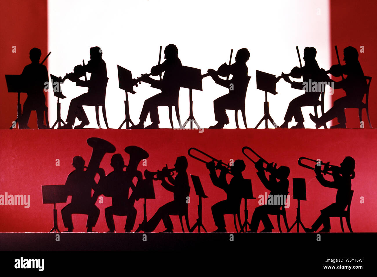 1970s GRAPHIC SILHOUETTED REPRESENTATION OF SEATED 1920s HOT JAZZ BAND OF MUSICIANS PLAYING VIOLINS TUBAS TRUMPETS AND TROMBONES - km7093 PHT001 HARS COPY SPACE FULL-LENGTH PERSONS INSPIRATION MALES PROFESSION ENTERTAINMENT SPIRITUALITY MUSICIANS PERFORMING PERFORMING ARTS WIDE ANGLE SKILL OCCUPATION HAPPINESS SKILLS LEISURE STRENGTH SILHOUETTED AND CAREERS EXCITEMENT POWERFUL RECREATION OF AUTHORITY OCCUPATIONS VIOLINS BANDSTAND TUBAS CONCEPTUAL STYLISH ANONYMOUS COOPERATION MID-ADULT MID-ADULT MAN TOGETHERNESS 12 OLD FASHIONED REPRESENTATION TRUMPETS TWELVE Stock Photo