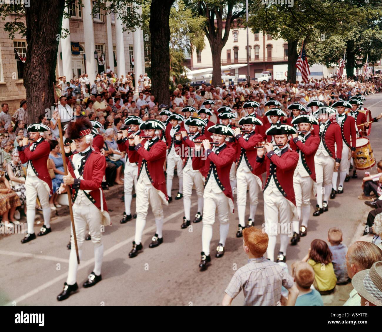 1960s UNITED STATES ARMY OLD GUARD FIFE AND DRUM CORPS MARCHING IN SMALL TOWN PARADE WELLSBORO PA USA - kp1368 SHE001 HARS LIFESTYLE ACTOR HISTORY CELEBRATION FEMALES JOBS UNITED STATES COPY SPACE FULL-LENGTH DRUMS PERSONS UNITED STATES OF AMERICA FESTIVAL MALES TEENAGE GIRL TEENAGE BOY LAUREL PROFESSION ENTERTAINMENT SPECTATORS MUSICIANS NORTH AMERICA FREEDOM NORTH AMERICAN PERFORMING ARTS WIDE ANGLE SKILL OCCUPATION SKILLS HIGH ANGLE STRENGTH VICTORY CAREERS EXCITEMENT PA POWERFUL BASS PRIDE AUTHORITY ENTERTAINER OCCUPATIONS UNIFORMS SNARE DISTINCTIVE CONCEPTUAL ACTORS FIFE STYLISH 1781 Stock Photo