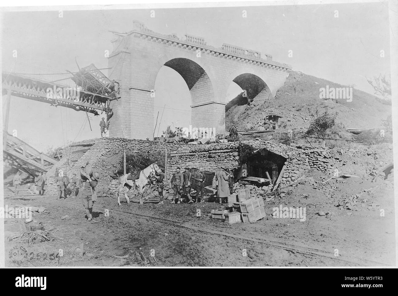 World War I photographs; Scope and content:  Army photographs. Battle of St. Mihiel-American Engineers returning from the front; tank going over the top; group photo of the 129th Machine gun Battalion, 35th Division before leaving for the front; views of headquarters of the 89th Division next to destroyed bridge; Company E, 314th Engineers, 89th Division, and making rolling barbed wire entanglements. Stock Photo