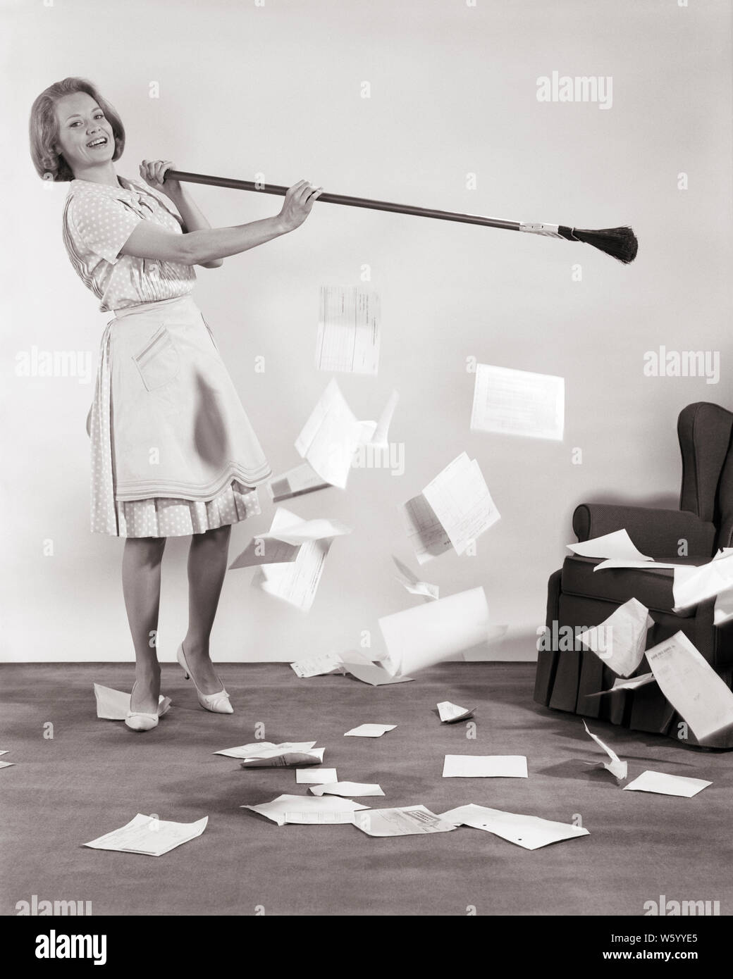 1960s WOMAN WITH BROOM SWEEPING UP PAPERS BILLS MAKING A CLEAN SWEEP STARTING FRESH ANEW - s15420 HAR001 HARS FULL-LENGTH LADIES PERSONS BROOM CONFIDENCE B&W FREEDOM GOALS HOMEMAKER FRESH HAPPINESS HOMEMAKERS CHEERFUL SWEEPING EXCITEMENT EXTERIOR POLKA DOTS PRIDE OPPORTUNITY UP AUTHORITY HOUSEWIVES SMILES JOYFUL STYLISH SOLUTIONS SWEEP YOUNG ADULT WOMAN BLACK AND WHITE CAUCASIAN ETHNICITY HAR001 HIGH HEELS OLD FASHIONED Stock Photo