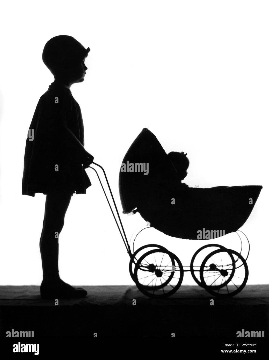 1920s ANONYMOUS SILHOUETTE OF LITTLE GIRL WEARING CLOCHE HAT PUSHING BABY DOLL IN BABY CARRIAGE - s1710 HAR001 HARS TRANSPORTATION B&W CARRIAGE DREAMS HAPPINESS LEISURE SILHOUETTED RECREATION CLOCHE IN OF CONNECTION CONCEPTUAL STYLISH ANONYMOUS BABY DOLL GROWTH JUVENILES RELAXATION TOGETHERNESS BABY CARRIAGE BLACK AND WHITE HAR001 OLD FASHIONED Stock Photo