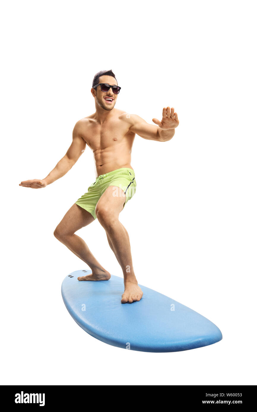 Full length shot of an attractive young surfer on a surfboard isolated on white background Stock Photo