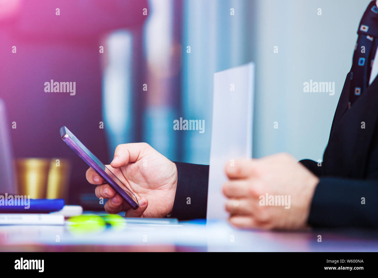 Business man holding purple smartphone Stock Photo