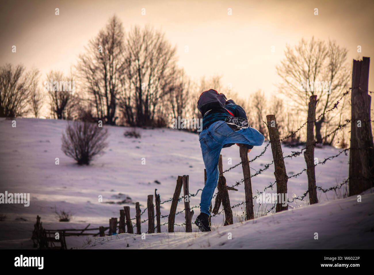 Person climbing over fence hires stock photography and images Alamy