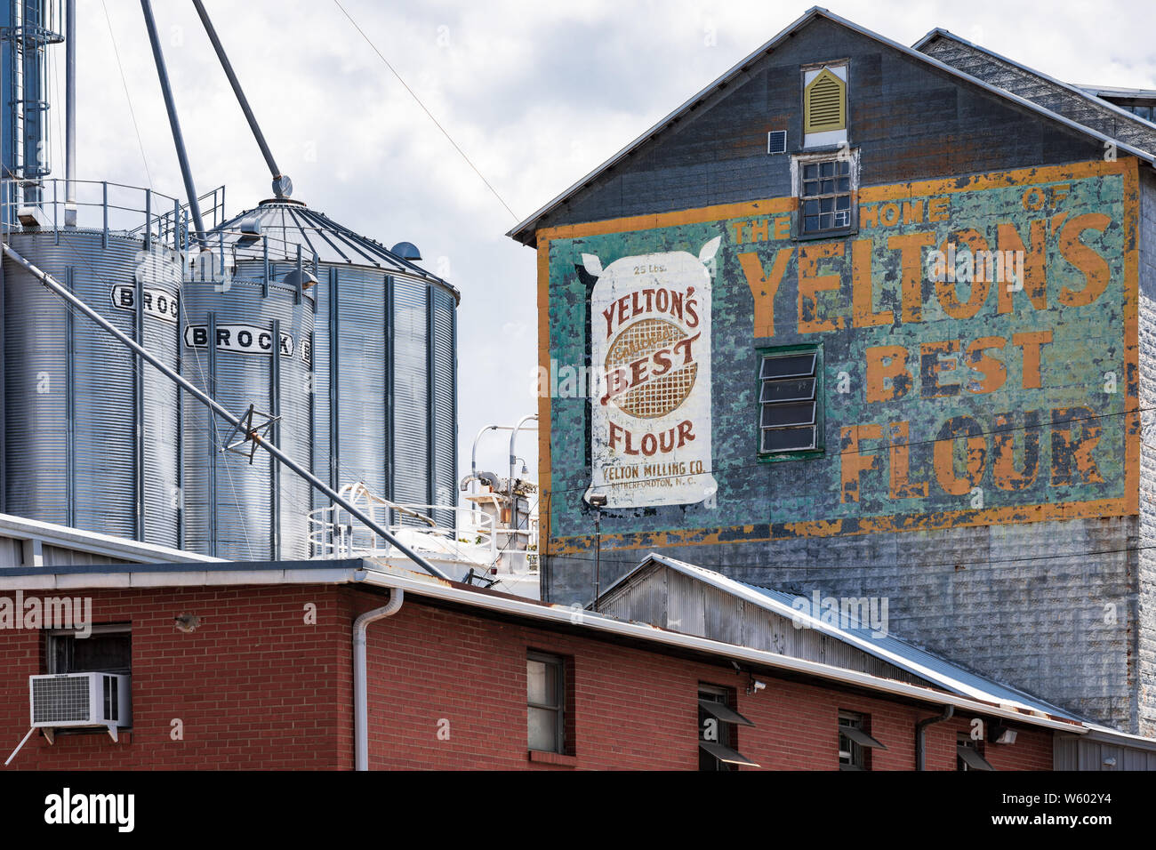 SPINDALE, NC, USA-27 jULY 19: Buildings, graneries, and sign of Yelton's Milling Co, aka Lakeside Mills, Inc. Stock Photo