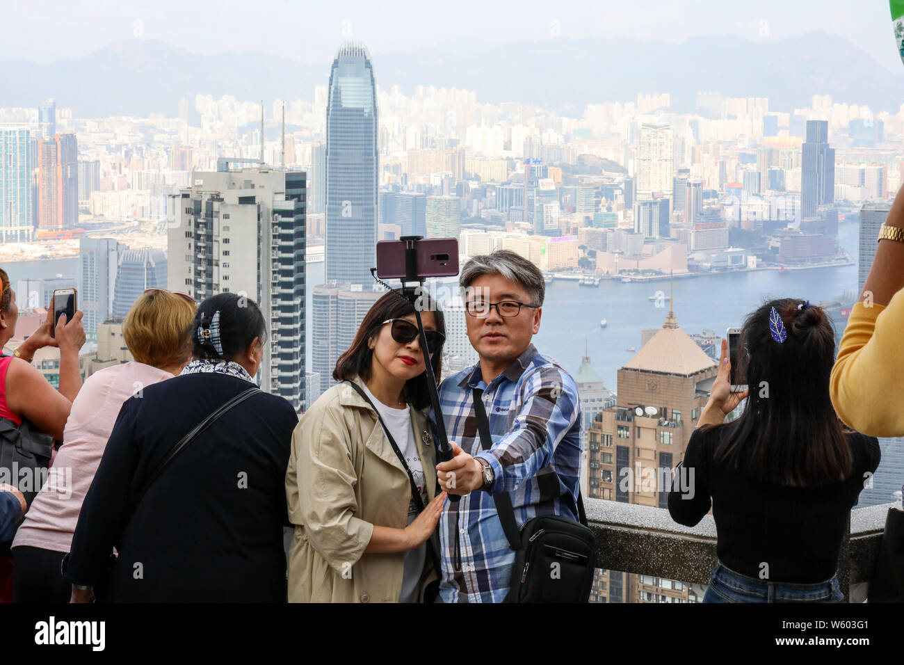 Middle-aged couple taking a selfie at Lion's Pavilion in Victoria Peak, Hong Kong Stock Photo