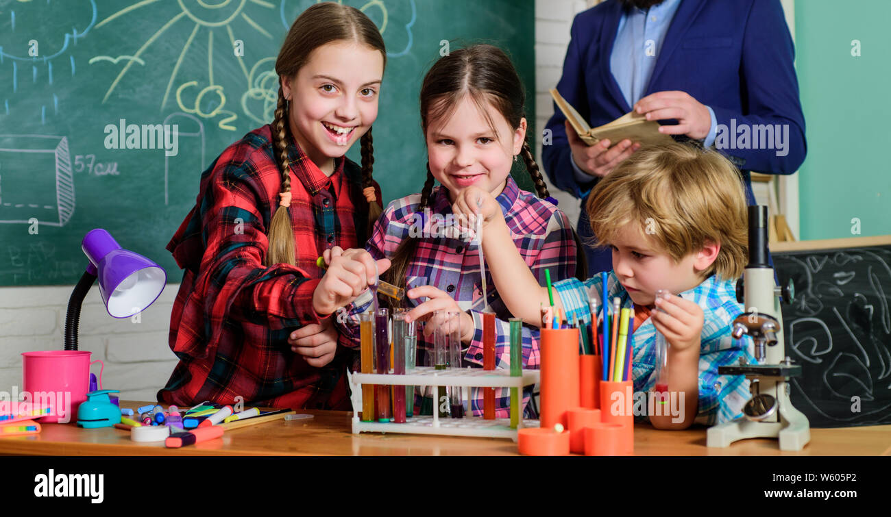 doing experiments with liquids in chemistry lab. children making