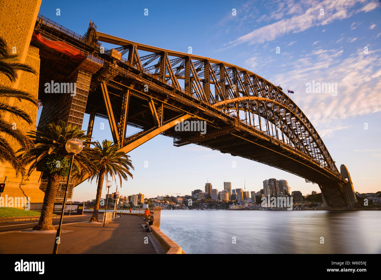 Horizontal image of the Sydney Harbour Bridge in Sydney, Australia at sunrise from Hickson Road Reserve. Stock Photo