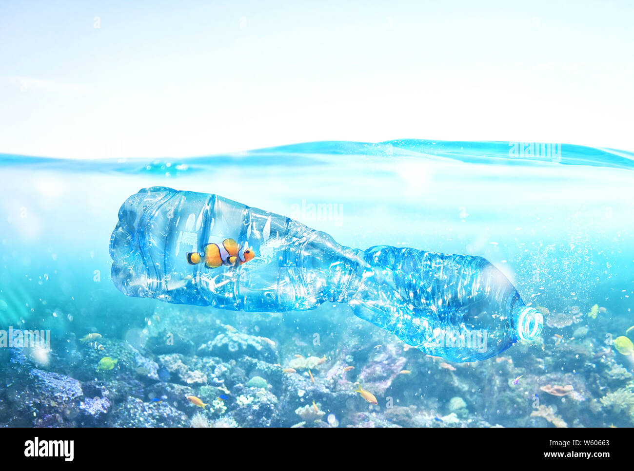 Fish trapped inside a bottle. Problem of plastic pollution under the sea concept. Stock Photo